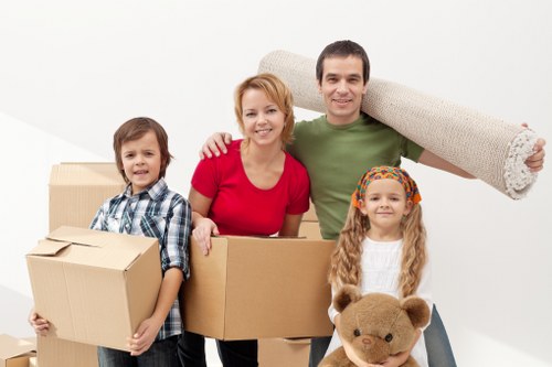 Packed moving boxes and wrapped furniture ready for transport in Sydenham