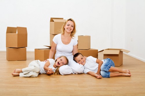 Professional movers carrying furniture through a flat entrance
