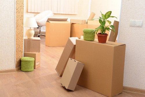 Professional movers carrying furniture in a Sydenham flat move