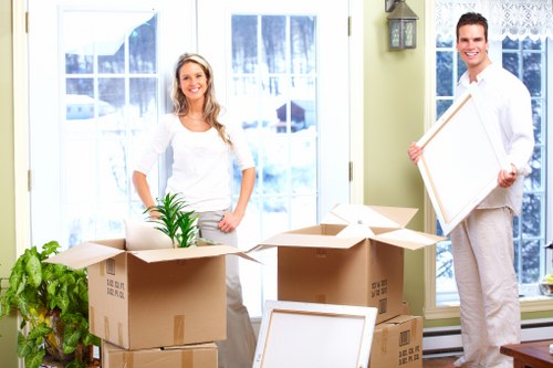 Team handling desks, files, and IT equipment during an office move