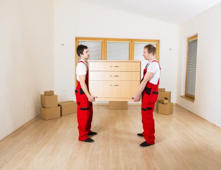 Moving team preparing boxes for a flat move in Sydenham